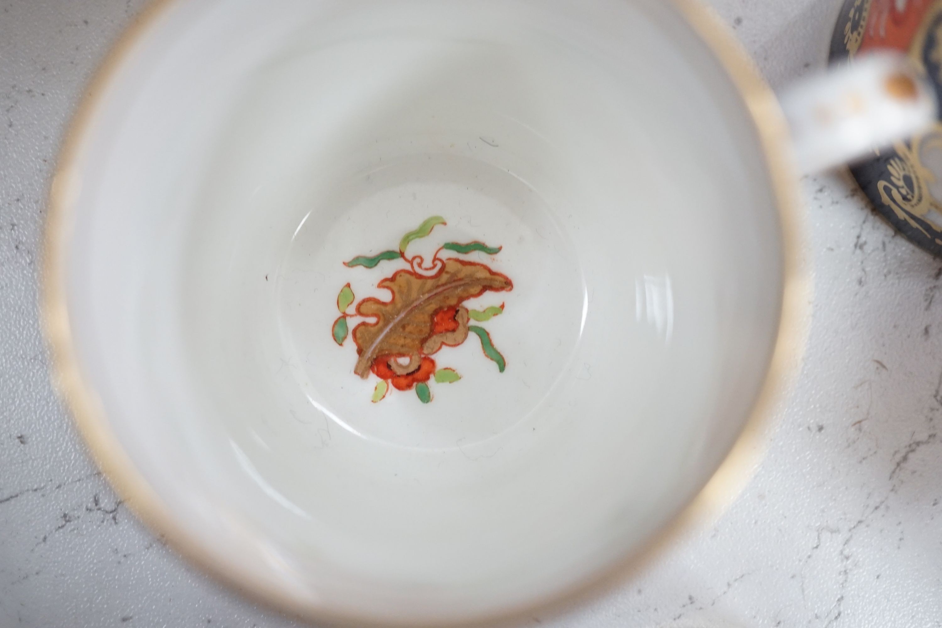 A mid 19th century English bone china fifty-two piece part tea and coffee service, decorated in an Imari pattern